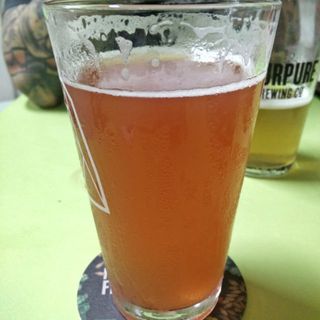 A photo showing this beer’s hazy, amber colour, atop a hawker centre table in Singapore