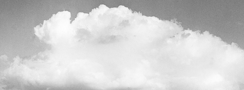 a black and white photograph of a large, volumnous cloud