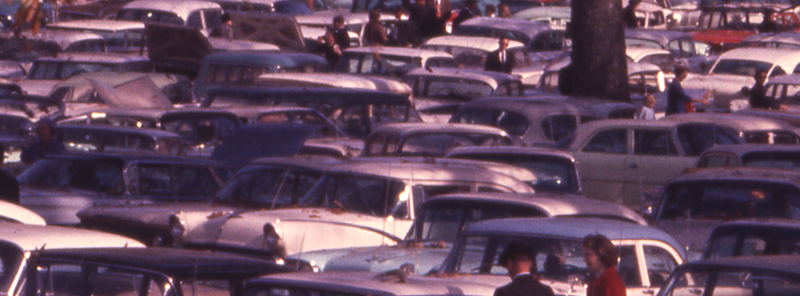 a photograph showing a dizzying scene of dozens, if not hundreds, of cars arranged tightly in all sorts of directions in what may be some kind of parking lot